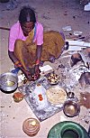 Homeless Woman Cooking on the Street
