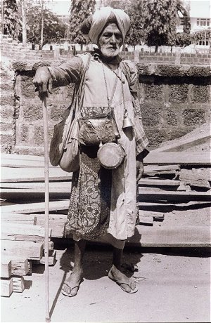 Beggar with Drums Outside a Temple