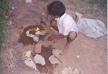 Boy Playing with stones and dirt