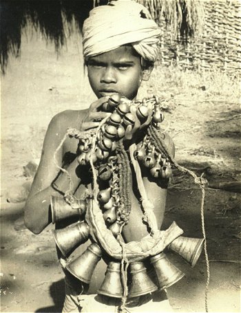 Tribal Boy Carrying Bells