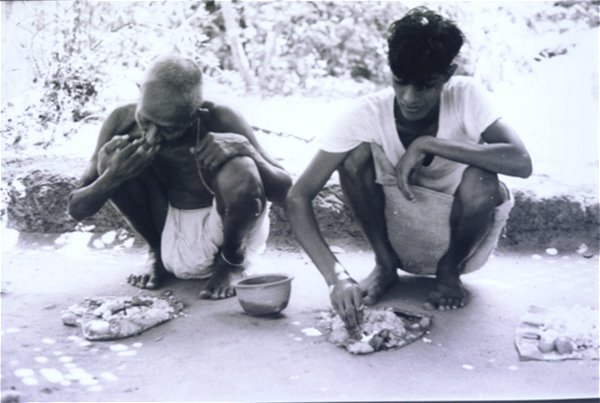 Villagers eating on plantain leaves