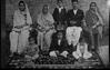 An Old photograph, probably Jha's family, Woman with embroidered sari, and children sitting on a embroidered carpet
