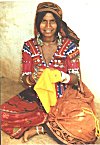 A Lambani lady embroidering a piece of yellow cloth