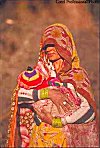 Rajasthani Woman in Veil  Carrying Child